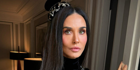 Demi Moore with long, glossy hair photographed against a neutral background