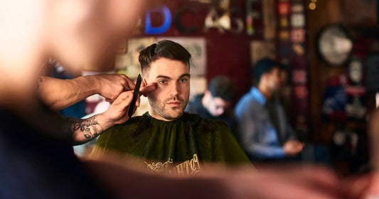Barber giving a man a dramatic haircut after years of hair growth in a barbershop