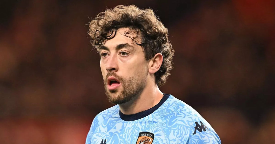 Hull City footballer during a Championship match under stadium lights