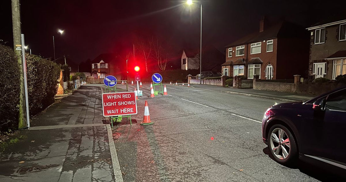 Temporary traffic lights on a busy Greater Manchester street causing queues