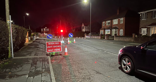 Temporary traffic lights on a busy Greater Manchester street causing queues