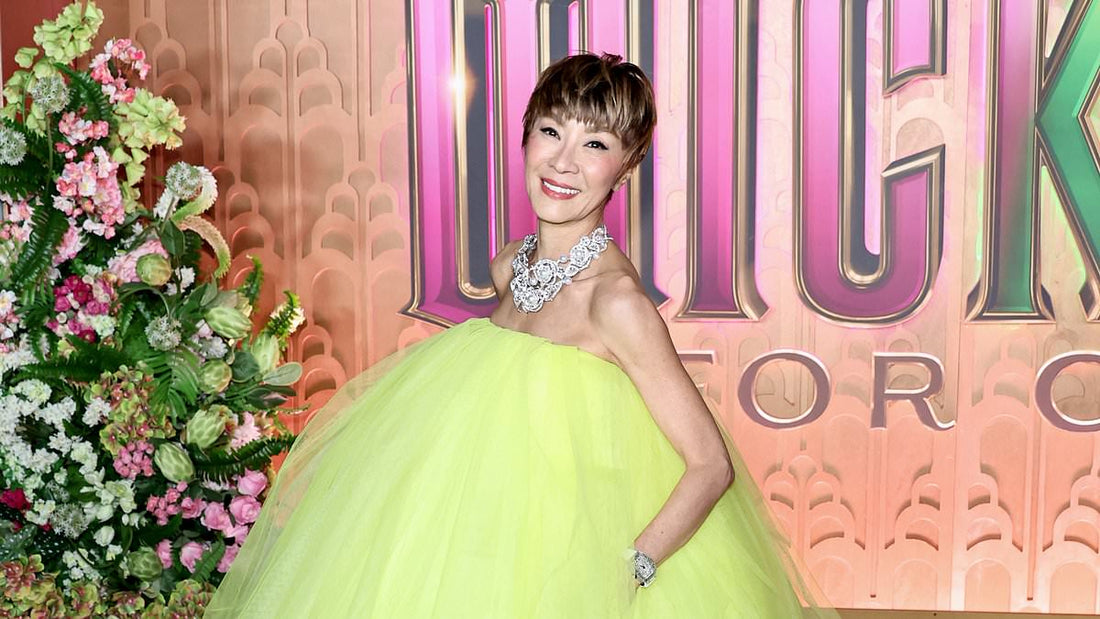 Michelle Yeoh with freshly cropped short hair in neon tulle dress on red carpet
