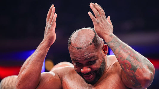 A boxer in the ring after his hairpiece comes loose during a bout