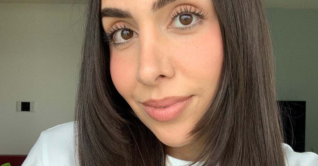 Woman with long, loosely layered J-shape haircut showing soft movement at the ends