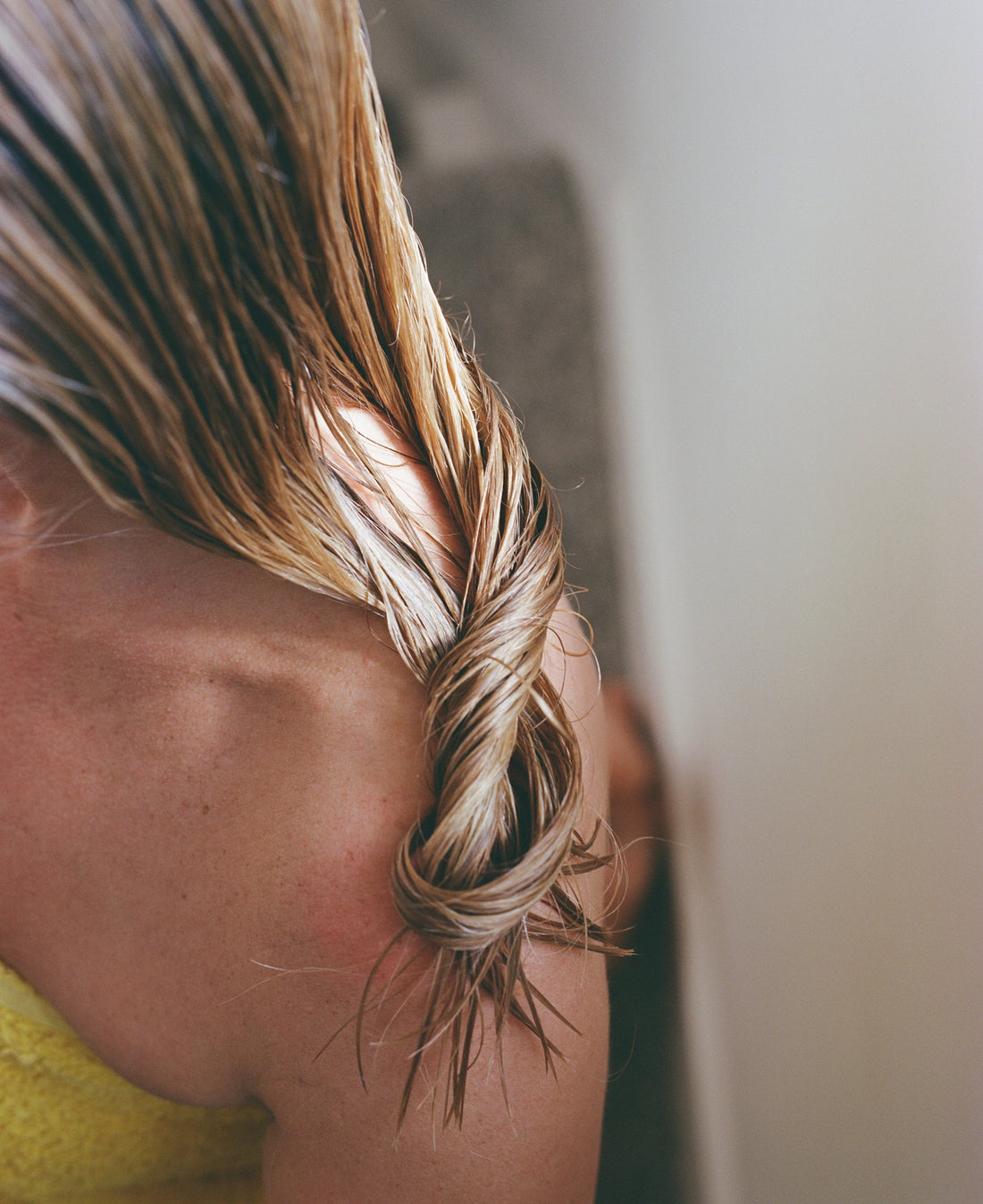 Woman touching her hair as loose strands fall during winter