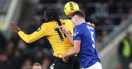 Premier League match moment with Everton and Wolves players contesting a challenge