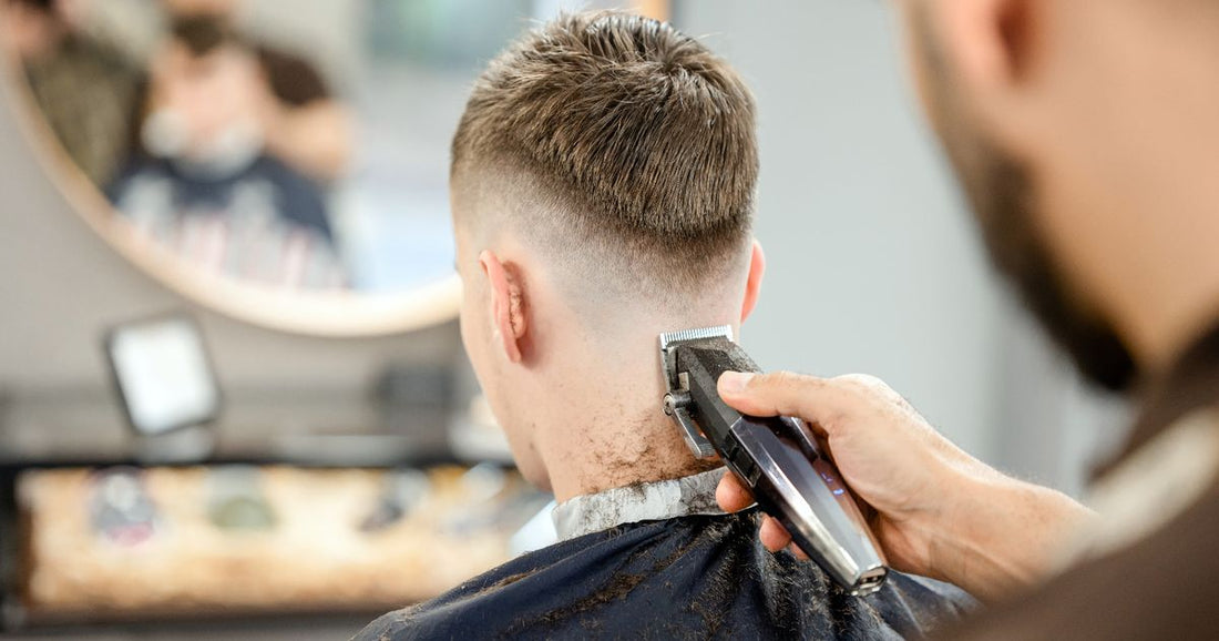 Young man receiving a haircut in a barbershop