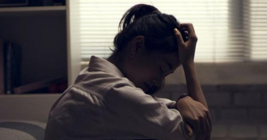 Young person touching their hair, representing shame-related hair-pulling