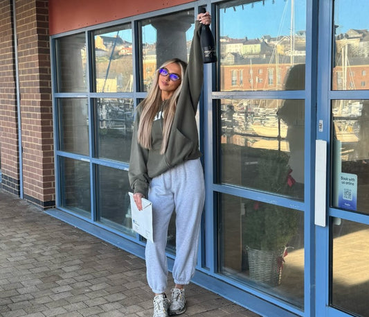 A young salon owner standing in a modern hair studio interior