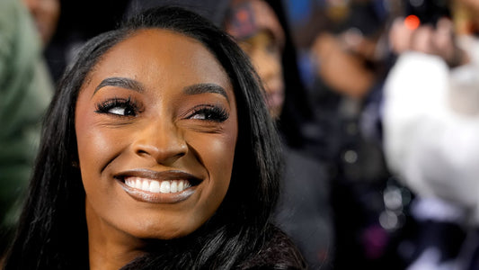 Simone Biles at an NFL game debuting a sleek new hairstyle