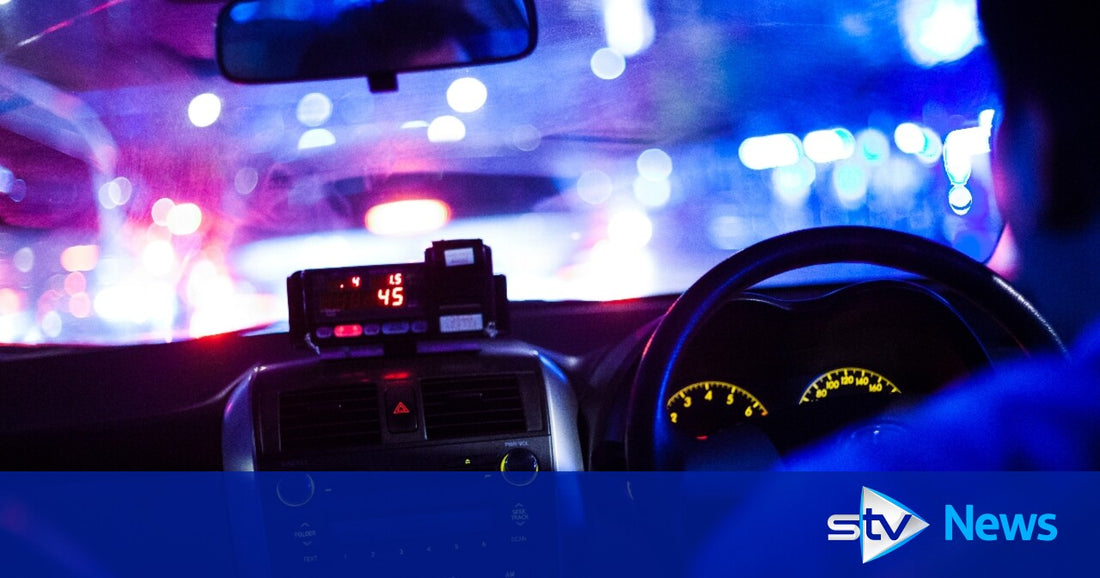 Taxi parked on a UK street near a rank on a cloudy day