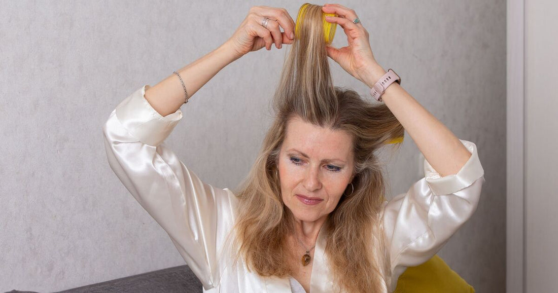 Woman wearing a soft layered cut with face-framing pieces and natural-looking volume