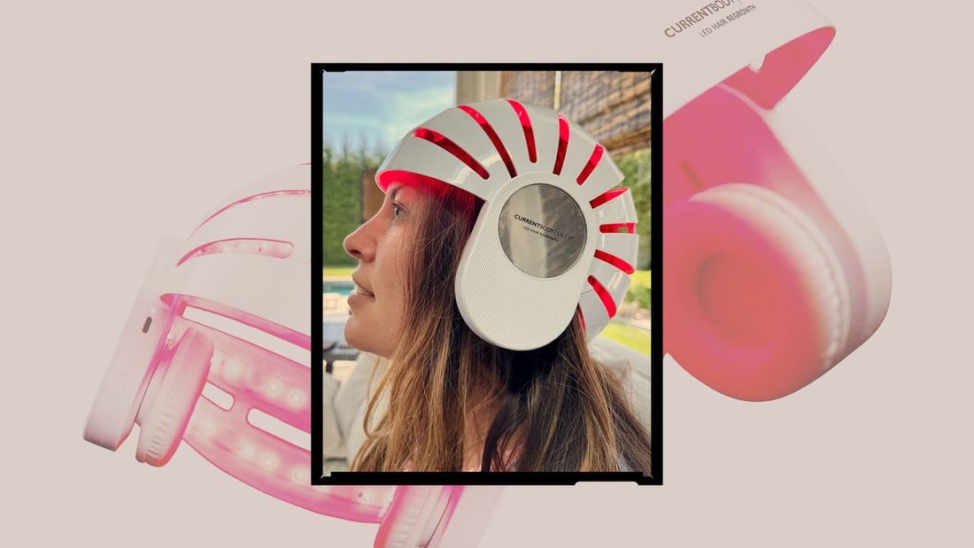 A person wearing a red-light LED hair-growth helmet in a home setting