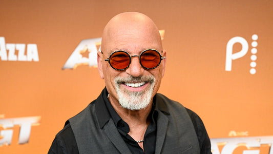 Howie Mandel with long curly brown hair in a vintage throwback photo