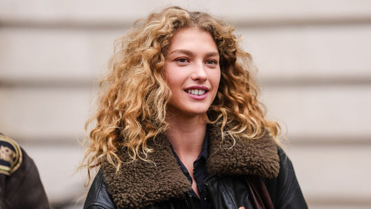 Model with softly textured, slightly messy hair in a candid street-style moment
