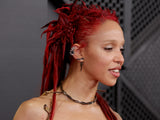 FKA twigs wearing an anthurium-red basketweave hairstyle with spiked locs at the Grammys