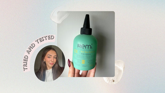 A haircare flatlay with a scalp exfoliator product and styling tools