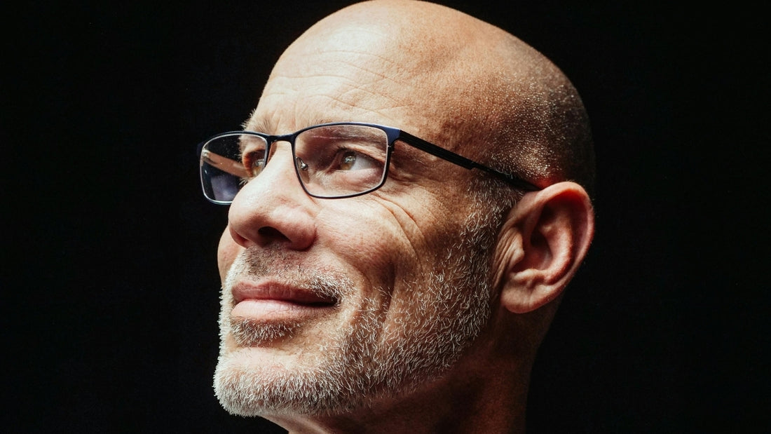 Close-up of a hopeful bald man looking into the distance