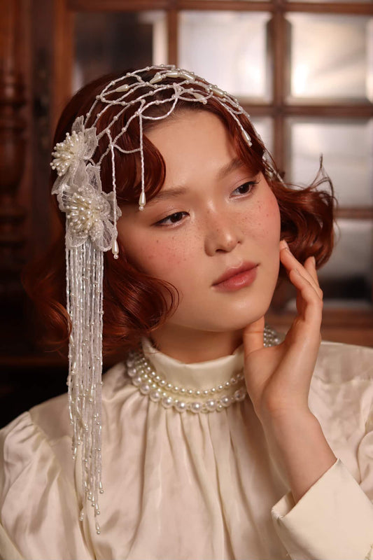 Close-up of intricate embroidered textile-inspired hair art details