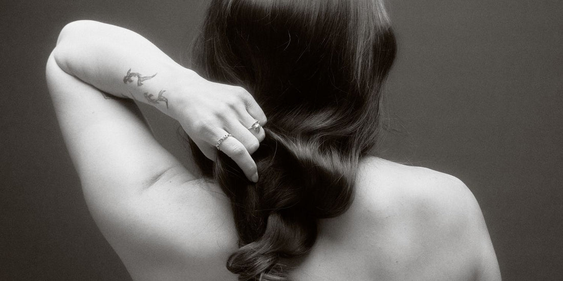 Long-haired woman considering a haircut and reflecting on identity and change