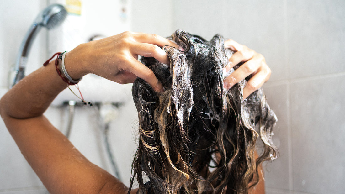 Hair transplant surgeon explaining common shower mistakes that damage hair, studio portrait