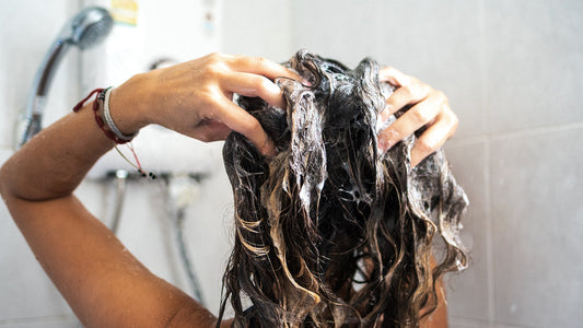 Hair transplant surgeon explaining common shower mistakes that damage hair, studio portrait