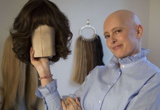 Woman with curly hair pictured in a portrait-style image