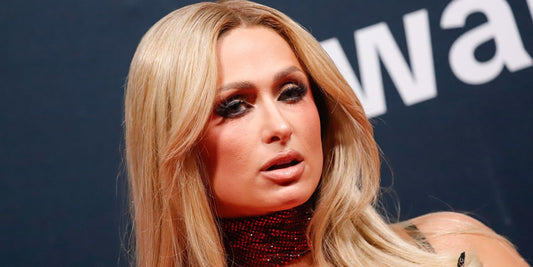 Paris Hilton wearing a hat and sunglasses as her hair appears a darker shade