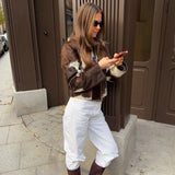 Model with sleek, glossy ponytail-style finish showing the pony hair trend