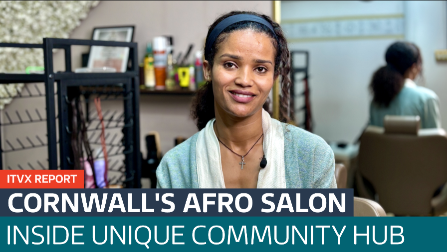Afro hair salon interior with stylist chair and artwork, from ITV News report
