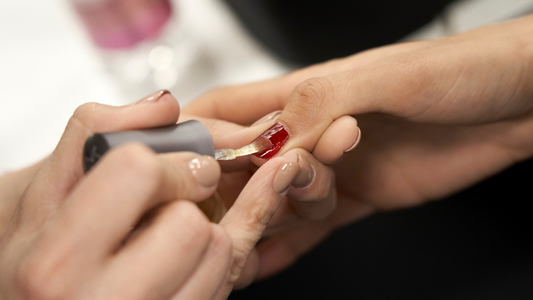 Close-up of hands showing healthy, shiny nails and hydrated cuticles