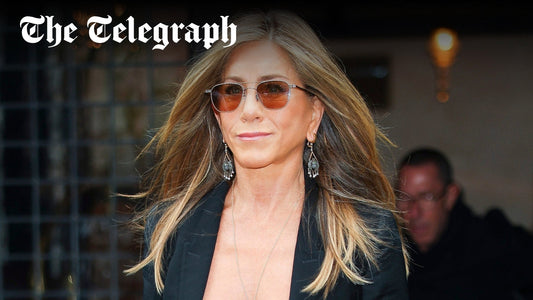 Jennifer Aniston with softly blended grey highlights and textured mid-length hair