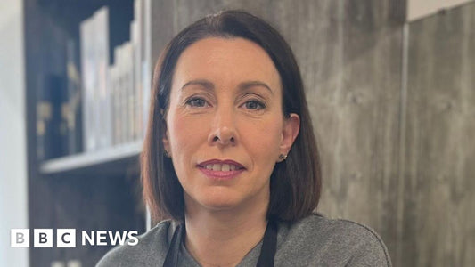 A hairdresser in a salon setting discussing professional training