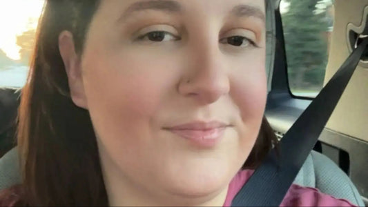 A woman with freshly cut hair looking upset in a salon setting