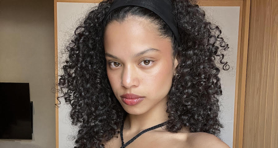 Woman with defined curly hair showing natural curl pattern
