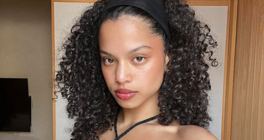 Woman with defined curly hair showing natural curl pattern