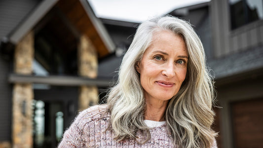 Close-up of grey eyebrows alongside grey hair, showing natural brow texture
