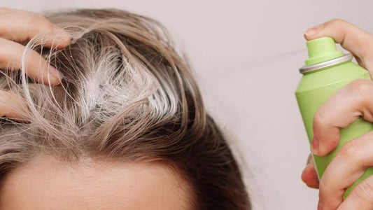 Dry shampoo spraying onto hair roots, illustrating potential product build-up
