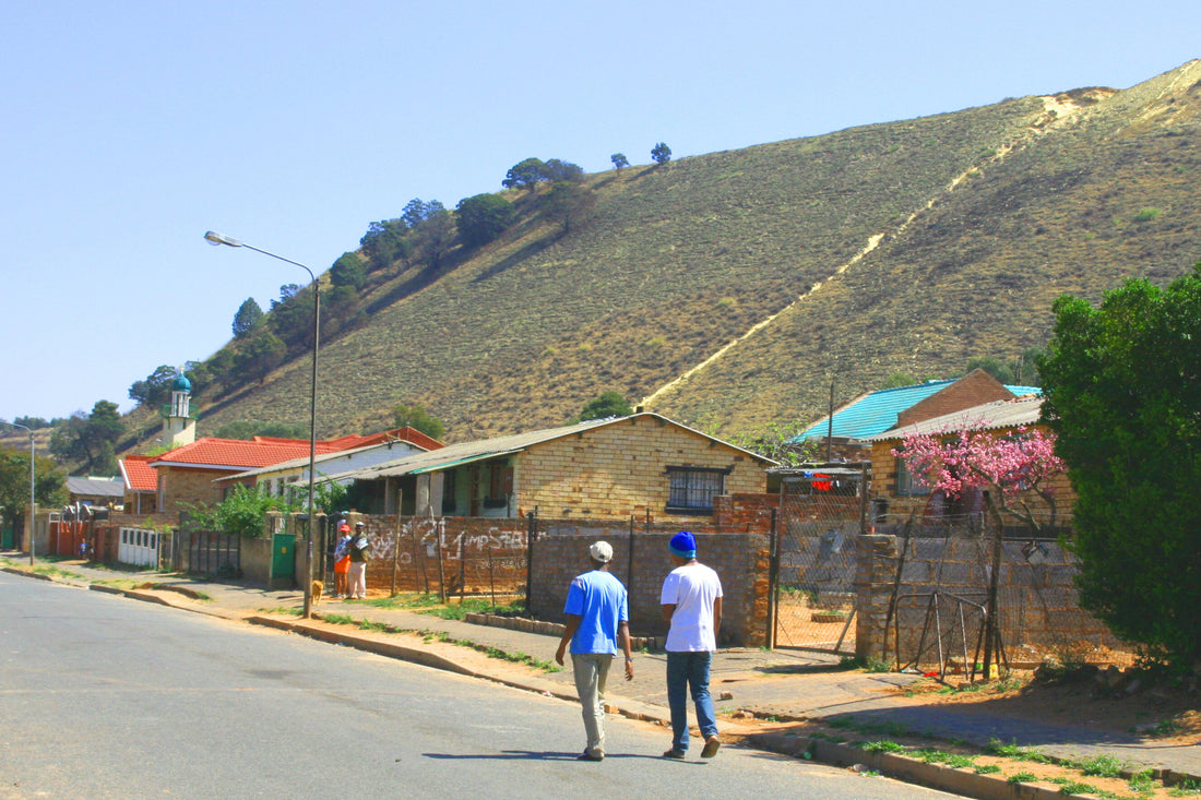 A gold mine waste dump near homes, where windblown dust can travel into communities