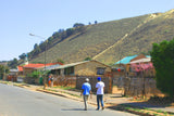 A gold mine waste dump near homes, where windblown dust can travel into communities