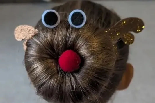 Young girl with a festive reindeer bun hairstyle for Christmas