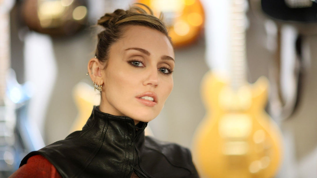 Miley Cyrus with tousled curtain bangs styled in a relaxed, rockstar-chic finish