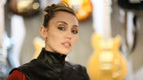 Miley Cyrus with tousled curtain bangs styled in a relaxed, rockstar-chic finish