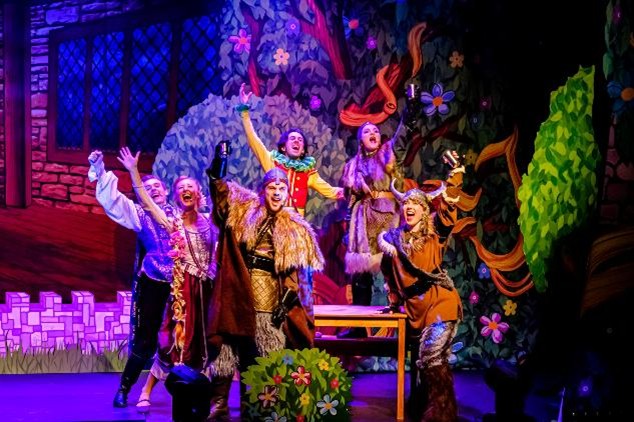 Performer as Rapunzel in a stage production with long hair