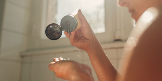Woman washing thinning hair with rosemary shampoo for fuller-looking strands