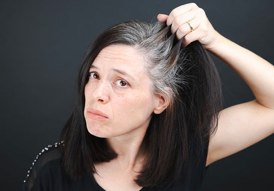 Person's hair with grey strands illustrating stress-related greying
